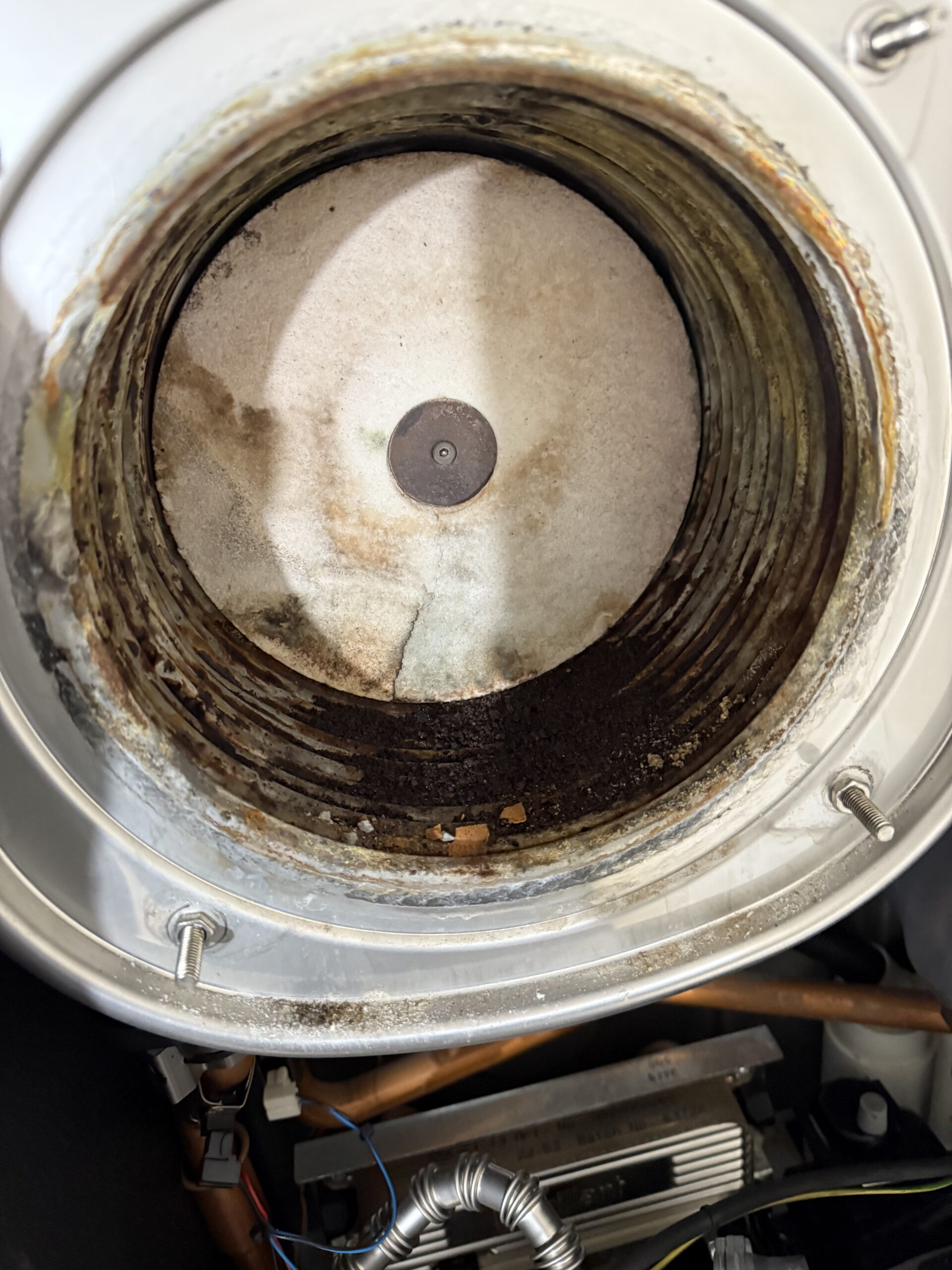 Heating engineer repairing a boiler in a home in Exmouth