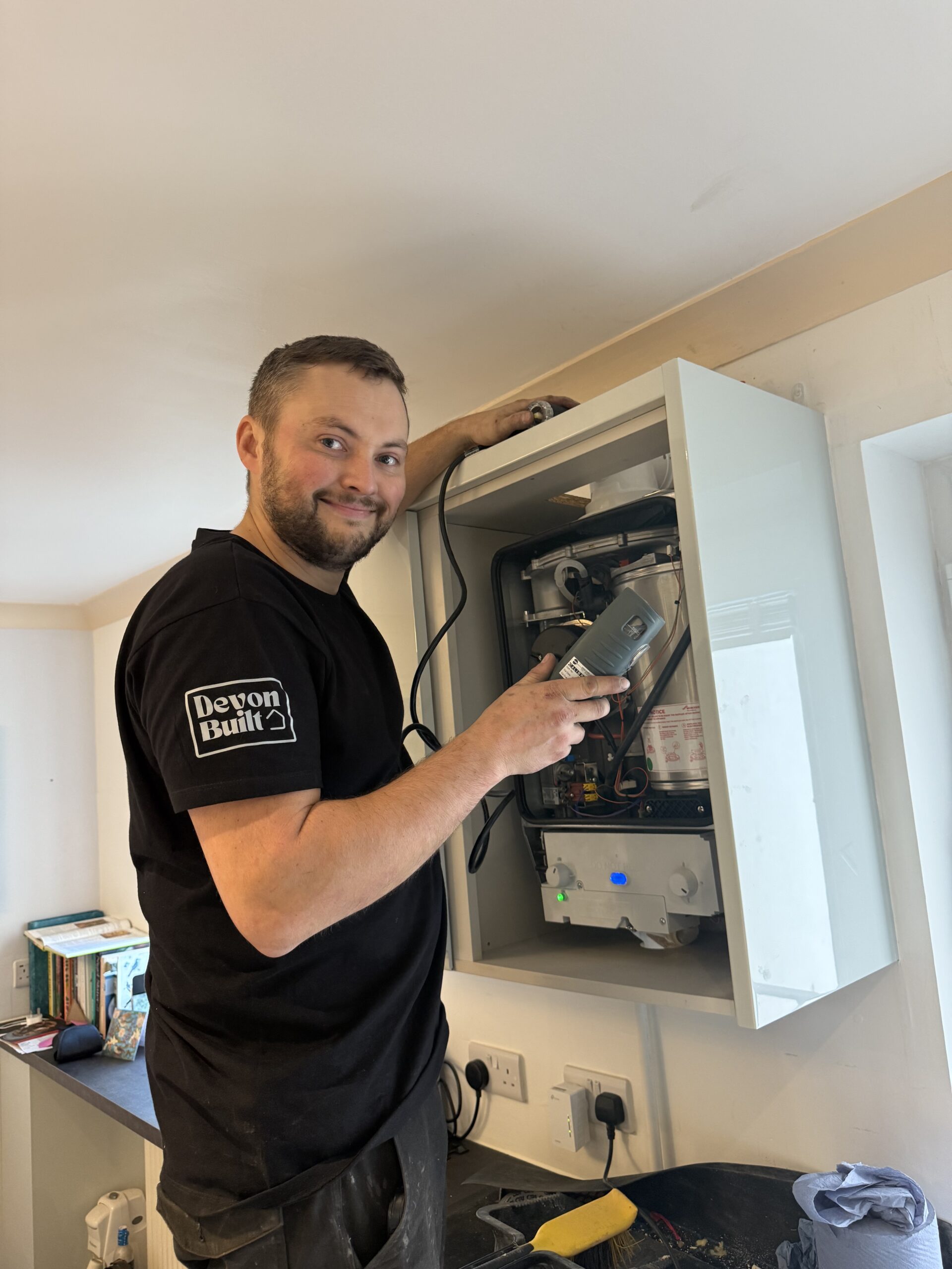 Heating engineer installing a new boiler in a home in Exmouth