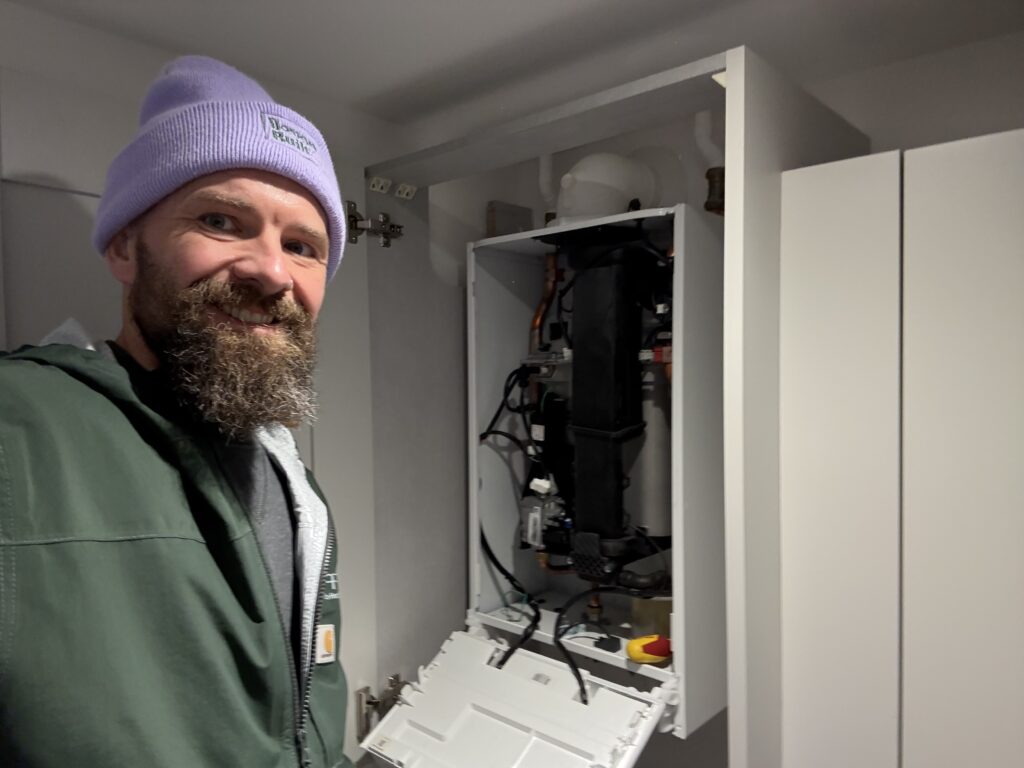Heating engineer performing a boiler service in a home in Exmouth